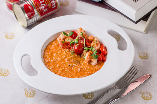 Pink risotto with brown tomatoes and tiger prawns